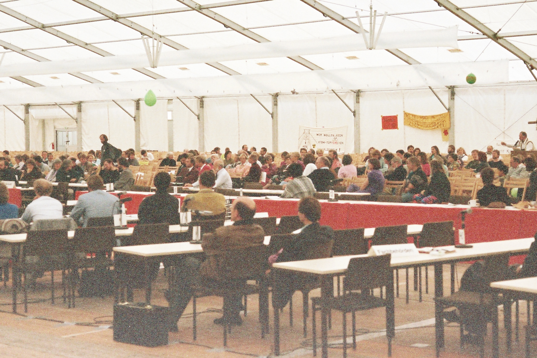 A large tent in which people sit at tables.