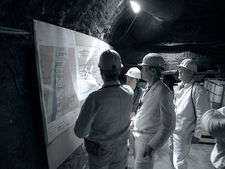Visitors in front of a display board.