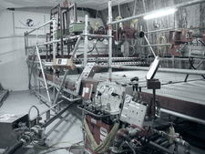 View of the control desk of the drill rig, below left is the pneumatic hose for the drilled material.