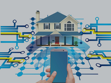 Smartphone im Vordergrund, im Hintergrund Haus