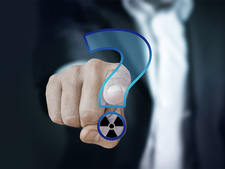 A finger points to a question mark with a radioactivity symbol