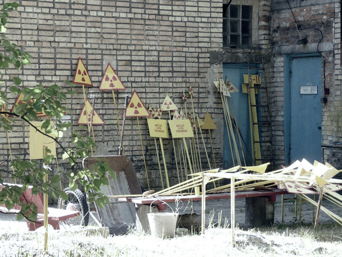 Warning signs in the sun in front of a workshop