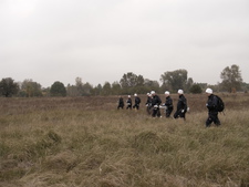 The group paces the field off with measuring instruments 