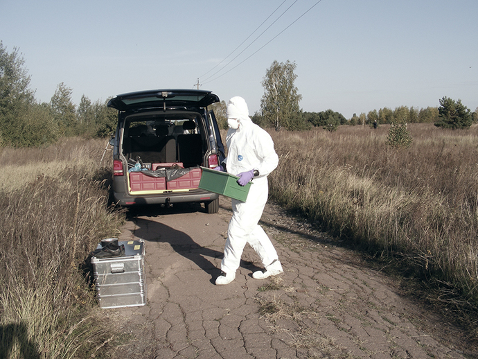 The box with a soil sample is carried to the car