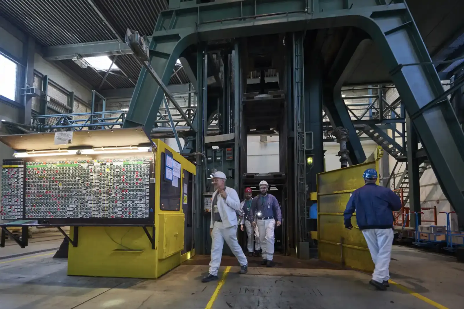 Miners leave the pit cage of the Asse II mine in the shaft hall
