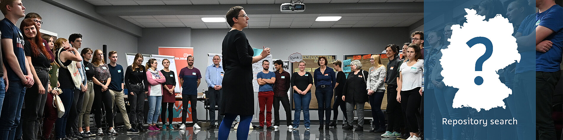 Staff member speaks in front of people