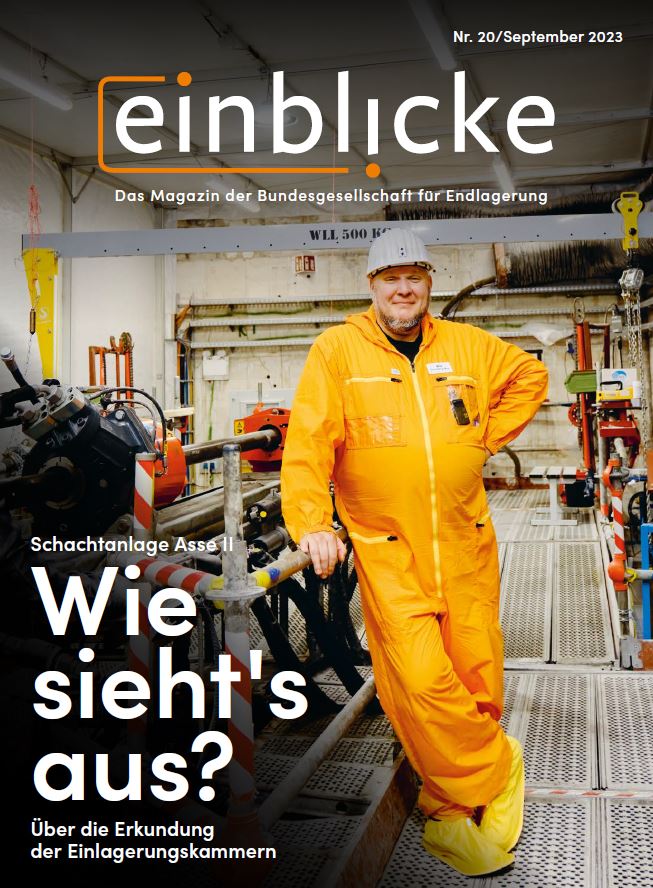 Titelseite des Einblicke-Magazins Nummer 20. Darauf zu sehen: Ein Bergmann in Arbeitskleidung und mit Schutzhelm neben einer großen Maschine. Daneben der Titel: "Wie sieht's aus? Über die Erkundung der Einlagerungskammern"