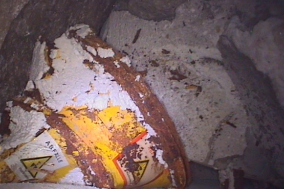 A barrel with radioactive waste in storage chamber 7