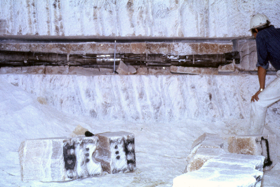 Mit Hilfe von Erhitzerversuchen wird untersucht, wie sich Salz unter dem Einfluss von Wärme verhält. Metal parts in a longitudinal cut hole in a salt block.