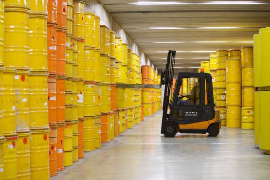 A forklift truck transports a drum of radioactive waste