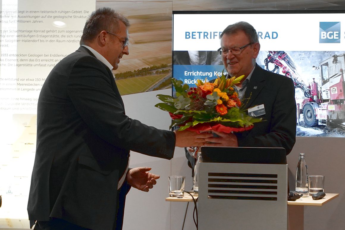Verabschiedung des Infostellenleiters Junkert Ein Mann überreicht einen Blumenstrauß