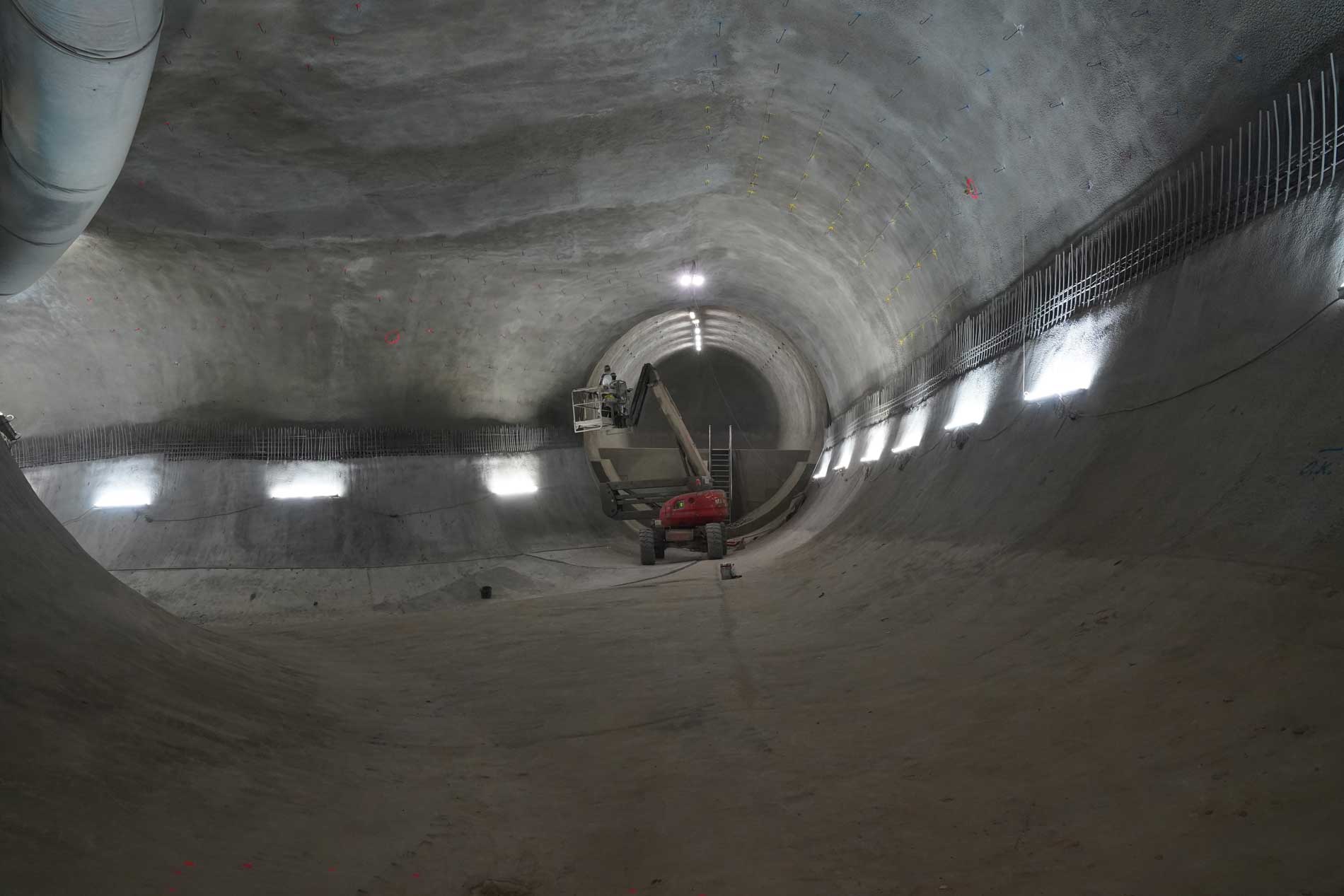 A worker on a lifting platform is working on the installation of an inner shell of a mine room.