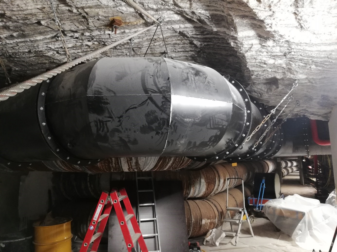 Eine große Metallröhre wird im Bergwerk installiert