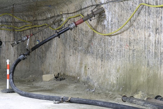 Eine Rohrleitung durchdringt die Wand zu einer Abbaukammer unter Tage.